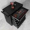 A black tool cart with several drawers, one of which is open and filled with screwdrivers and other tools. A red and black cordless drill sits on top of the cart. Produktbild-Vorschau