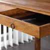 Close-up of an open wooden drawer with a pen inside. Náhled obrázku produktu