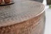 Close-up of the textured surface of a round copper coffee table. Produktbild-Vorschau