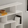 Close-up view of a white, modern modular bookshelf with books and a wooden bowl. Anteprima dell’immagine prodotto