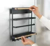 A person's hands are shown attaching a magnetic shelf organizer to a refrigerator. Voir les images du produit