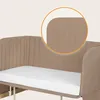 A close-up view of the padded side of a crib, highlighting the stitching detail and rounded corner. Náhľad obrázku produktu