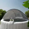 An outdoor whirlpool with a sunshade and two drinks on a tray. Náhled obrázku produktu