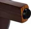 A close-up view of the bottom of a wooden furniture leg with a black rubber stopper. Podgląd zdjęcia produktu