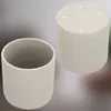 Two beige cylindrical pots are shown against a light gray background. One pot is viewed from the side, showing its open top, while the other is viewed from the top, revealing four small white dots. Anteprima dell’immagine prodotto