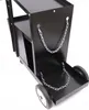 A close-up view of a black metal welding cart with chains for securing gas cylinders. Produktbild-Vorschau