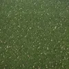 A top-down view of a green carpet or floor covering with scattered white flowers. Produktbild-Vorschau