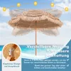 A beach umbrella on a beach with the sun in the sky. Produktbild-Vorschau