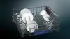 The inside of a dishwasher rack filled with clean dishes and glasses. Produktbild-Vorschau