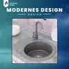 A modern kitchen sink with a gray granite-look finish and a matching faucet, set against a blurred background with abstract blue and teal tones. Anteprima dell’immagine prodotto