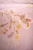 A close-up of a pink floral patterned fabric. Produktbild-Vorschau