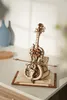 A wooden model of a cello with intricate gears and a bow, displayed on a wooden book-like stand. Voir les images du produit