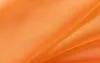 Draped orange fabric, likely a curtain or textile. Produktbild-Vorschau