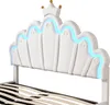 A close-up view of a white bed frame with a crown-shaped headboard and blue LED lighting. Náhled obrázku produktu