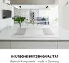 A modern kitchen with a white induction cooktop in the foreground and a living area in the background. Produktbild-Vorschau