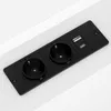A black power strip with two European-style outlets, a USB-A port, and a USB-C port, mounted on a white surface. Produktbild-Vorschau