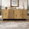 A modern sideboard with a geometric design is placed in a well-lit room, styled with a lamp and a vase of branches. Produktbild-Vorschau