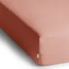 A close-up view of a peach-colored fitted sheet. Produktbild-Vorschau