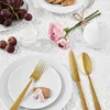 A table setting with grapes, flowers, and cutlery. Podgląd zdjęcia produktu