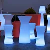An outdoor patio at dusk with illuminated bar stools and tables. Produktbild-Vorschau
