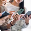 Three people are holding and looking at their smartphones. Produktbild-Vorschau