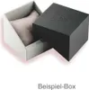 An open watch box with a pillow inside, and the lid is placed next to it. Produktbild-Vorschau