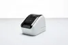 A white label printer is shown on a white surface with a white background. Produktbild-Vorschau