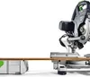 A Festool Kapp-Zugsäge KAPEX KS 60 E is shown on a white background, with a wooden plank resting on it. Podgląd zdjęcia produktu