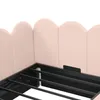 Close-up of a pink upholstered bed frame with a metal slatted base. Podgląd zdjęcia produktu