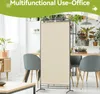 A room divider is set up in a room with furniture and plants. Voir les images du produit