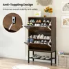 A shoe rack with shoes on display, next to a wall with artwork and a vase of flowers. Podgląd zdjęcia produktu