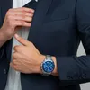 A man in a suit is adjusting his pocket, showing off his watch. Náhľad obrázku produktu