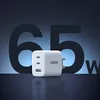 A white Ugreen 65W charger is shown in the foreground, with large, dark blue numbers '65' and the letter 'W' in the background. Náhľad obrázku produktu