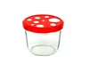 A clear studio shot of a glass jar with a red lid decorated with white dots, resembling a fly agaric mushroom. Náhled obrázku produktu