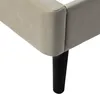 Close-up of a bed frame corner with a black leg. Voir les images du produit