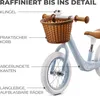 Close-up of a child's balance bike with labels pointing out its features. Produktbild-Vorschau
