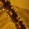 A close-up shot of warm white LED string lights wrapped around a wooden cylinder. Náhled obrázku produktu