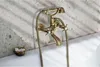 A close-up shot of a vintage-style bathtub faucet mounted on a speckled wall above a bathtub. Náhľad obrázku produktu
