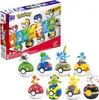 A product shot of a Mega Pokémon Trainer Team 8-Pack toy set, with the packaging in the background and the individual Pokémon figures with their Poké Ball bases in the foreground. Podgląd zdjęcia produktu