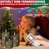 A child looking at a Christmas tree with LED candles and a remote control in the foreground. Produktbild-Vorschau