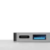 A close-up view of a USB-C hub with various ports, set against a white and light gray background. Voir les images du produit