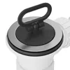 A close-up of a sink drain plug with a black handle and a silver rim. Náhled obrázku produktu