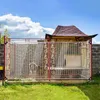 A dog is inside a fenced enclosure with a doghouse and a covered roof structure. The enclosure has a transparent cover with decorative elements. Náhled obrázku produktu