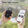 Hands holding a portable speaker and a smartphone displaying an equalizer app. Voir les images du produit