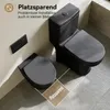 A black toilet and a toilet seat are shown in a bathroom setting, with text highlighting space-saving features. Náhľad obrázku produktu