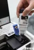 A hand is shown pouring ink from an Epson bottle into a printer. Náhľad obrázku produktu
