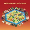 A board game setup with hexagonal tiles representing land and sea, surrounded by game pieces and cards. Anteprima dell’immagine prodotto