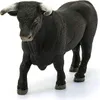 A black bull figurine standing on a white surface. Podgląd zdjęcia produktu