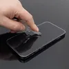 A hand is holding a key and touching the screen of a smartphone, demonstrating the scratch resistance of a screen protector. Podgląd zdjęcia produktu