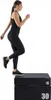A woman is performing a plyometric exercise on a jump box. Produktbild-Vorschau